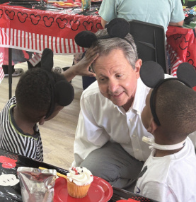 Gregg Weiss with children at a community celebration
