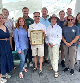 Gregg Weiss with residents holding a proclamation